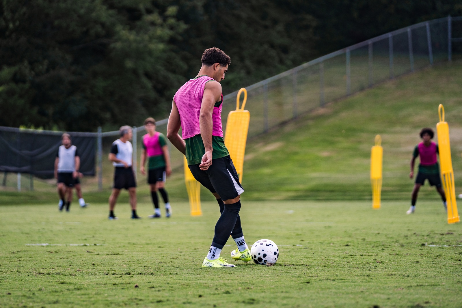Student athlete training session at college soccer pitch